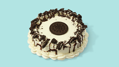 A delicious-looking cake decorated with chocolate chips and cookie dough.