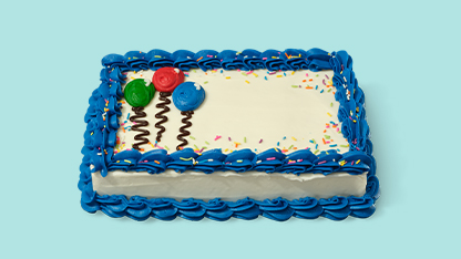 Birthday cake on blue frosted platter.